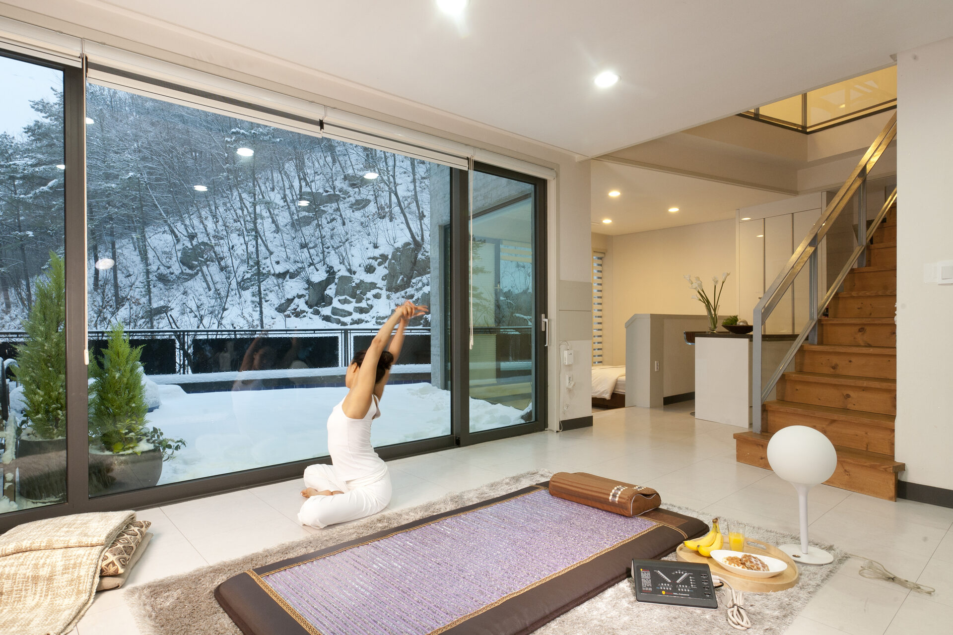 Woman relaxing near Biomat in wellness retreat setting